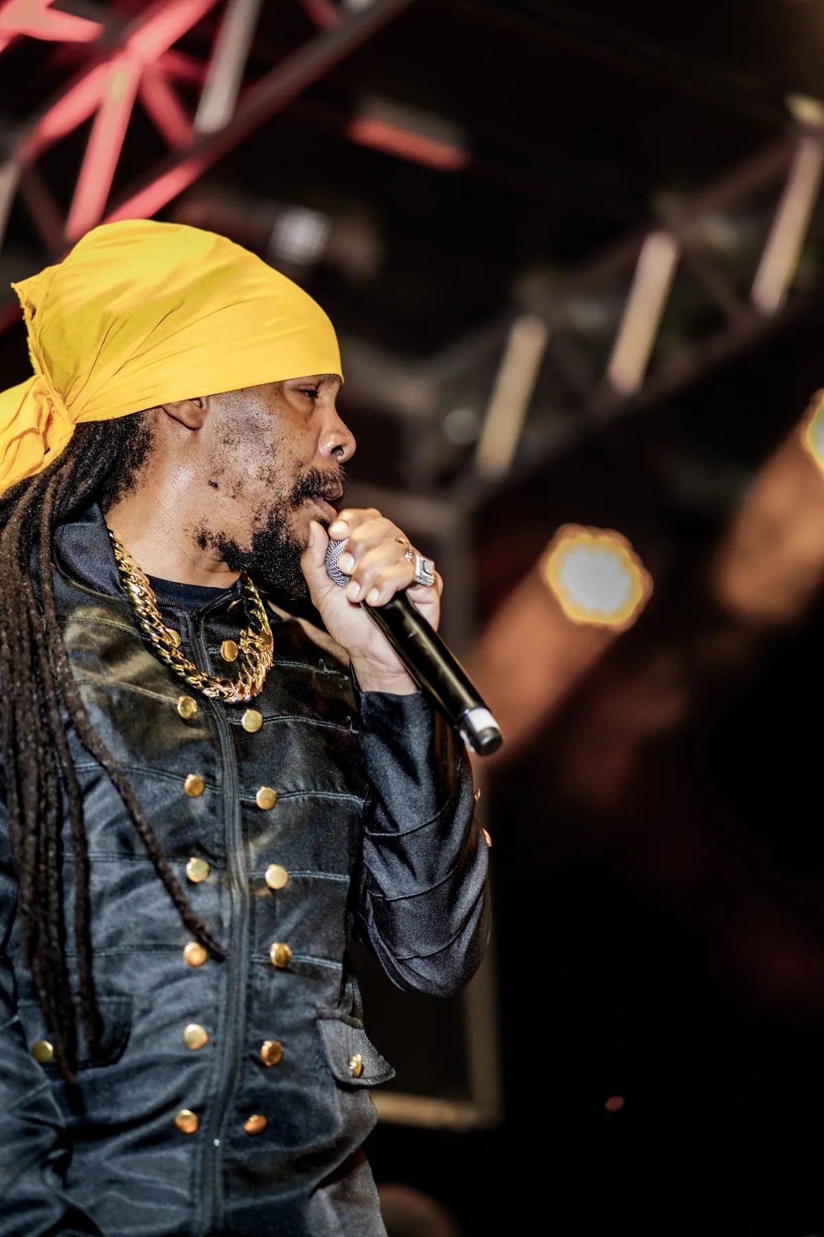 Turbulence in a yellow head wrap singing on the Culture Reggae Festival stage, 2024